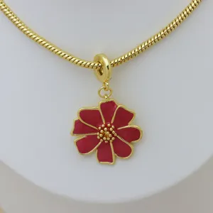 Detailed macro view of vibrant red enamel flower pendant on 18K gold plated snake chain necklace