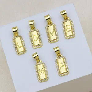 Detailed macro view showing six 18K gold-plated alphabet pendants with sparkling zircon edges.
