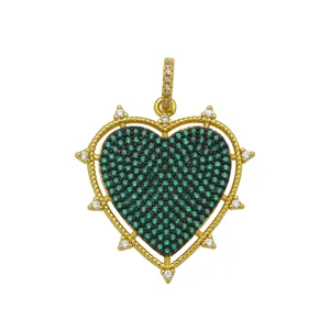 Exquisite detail of 18k gold plated heart pendant featuring green and black zircon stones.