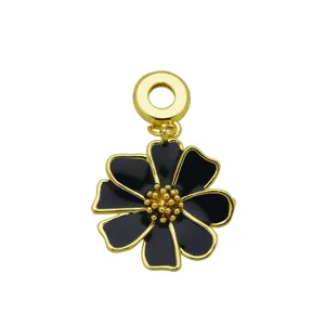 Detailed macro view of an 18K gold-plated flower pendant with black enamel finish.