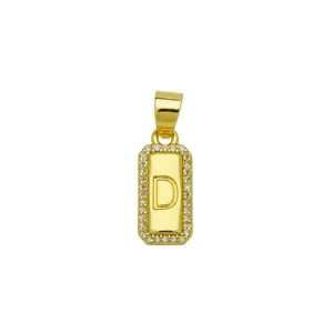 Macro detail of square 18K gold plated copper pendant with letter D and zircon stones