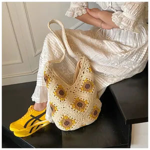 A detail view of this handmade crochet cotton bag with vibrant sunflower pattern
