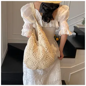 Handmade crochet sunflower shoulder bag worn with a lace dress in a summer scene