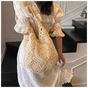 Handmade crochet cotton shoulder bag with sunflower pattern and hollow-out design on model