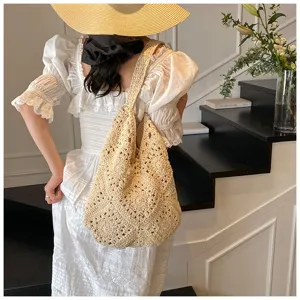 Elegant handmade crochet cotton shoulder bag with sunflower pattern worn by model