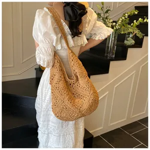 Detailed view of a handmade brown crochet shoulder bag with sunflower hollow-out pattern