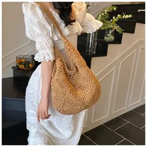 Handmade crochet cotton thread hobo bag with sunflower hollow pattern worn on shoulder
