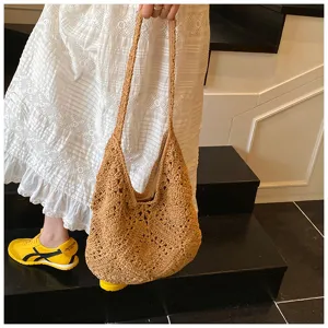 Close-up of handmade crochet sunflower bag with intricate hollow-out knit patterns