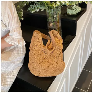 Detailed view of handmade sunflower pattern crochet shoulder bag in a lifestyle scene