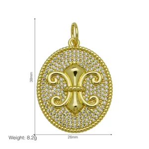 Close-up of 18k gold plated fleur-de-lis pendant with micro-pave zircons.