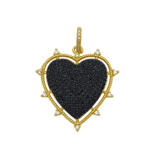 Exquisite macro detail of 18k gold plated heart pendant with black zircon pavé stones