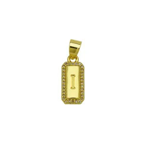 Detailed macro view of square 18K gold plated pendant featuring letter I and zircon border