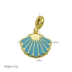 Detail macro view of blue enamel shell pendant charm in 18K gold plated copper finish