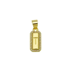 Close-up of gold-plated rectangular pendant with letter T and cubic zirconia border