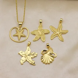Close-up detail of golden ocean style starfish and shell pendants on luxury satin fabric.