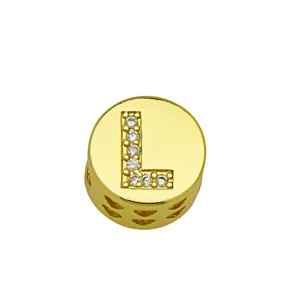 Detail of gold round charm with sparkling letter L and heart-shaped cutouts