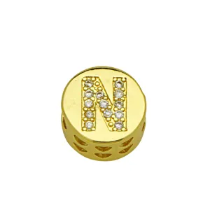 Detailed view of gold plated circular charm pendant with crystal letter N inlay