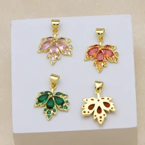 Detailed close-up of colorful zirconia maple leaf pendant, exquisite 18k gold plated brass jewelry.