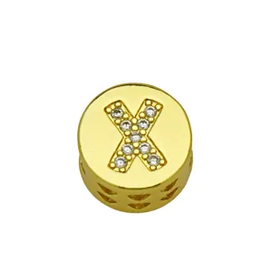 Close-up of golden round pendant charm featuring a crystal-studded letter X for DIY jewelry