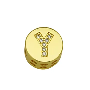 Close-up of a gold-plated round charm featuring a diamond-studded letter Y.