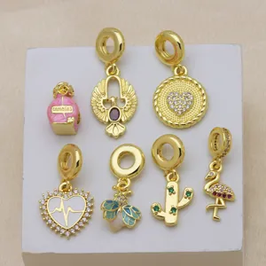 Detail shot of charm set featuring gold-plated designs including flamingo, cactus, and heart.