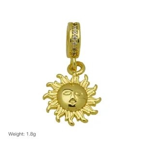 Gold sun charm detail showing smiling face and paved rhinestone bail, elegant jewelry piece.