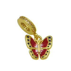 Gold butterfly dangle charm with red enamel and clear cubic zirconia stones for bracelet.