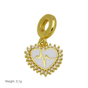 Gold-plated heart dangle charm with white enamel, pulse line design and sparkling cubic zirconia.