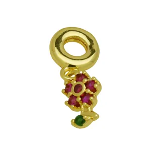 Detailed view of the gold-plated charm featuring a vibrant red and green floral design.