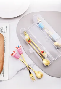 Set de cucharas y tenedores de acero inoxidable dorado con asas de silicona de dibujos animados.