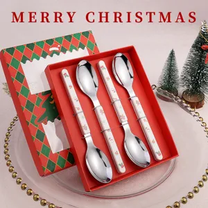 Christmas stainless steel spoon set detail view featuring ceramic handles and red gift box.