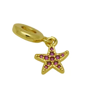 Gold-plated starfish dangle charm with sparkling pink cubic zirconia, detailed closeup view.