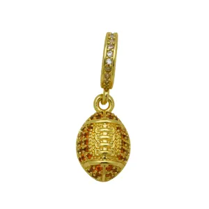 Gold-plated football pendant detail showing vibrant orange cubic zirconia and sparkling stone bail.
