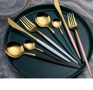 Stainless steel cutlery set with colored handles and gold finish. Premium flatware for dining.
