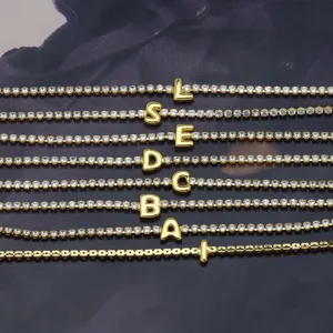 Gold tennis bracelet featuring sparkling rhinestone crystal pave and cute alphabet letter charms.