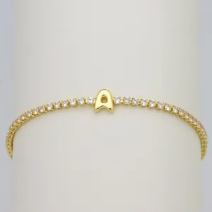Gold-plated tennis bracelet with cute bubble letter A charm and sparkling cubic zirconia.
