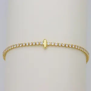 Exquisite Gold Tennis Bracelet Featuring Sparkling Cubic Zirconia and Cross Charm.