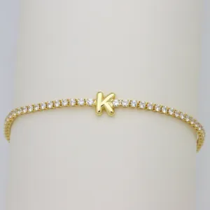 Gold tennis bracelet featuring a cute bubble letter K charm and sparkly cubic zirconia stones.