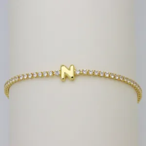 Gold-plated tennis bracelet with cute bubble letter N and sparkling cubic zirconia crystals.