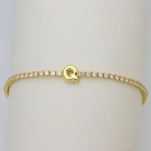 Gold tennis bracelet featuring a cute puffy balloon letter Q pendant set with sparkling cubic zirconia.