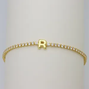 Gold tennis bracelet with sparkling cubic zirconia stones and a cute puffy letter R pendant.