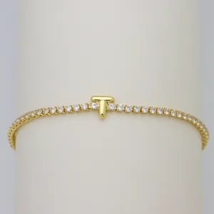 Gold tennis bracelet with puffy balloon letter T charm and sparkling cubic zirconia stones.