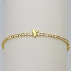 Detail of gold-plated tennis bracelet with sparkling cubic zirconia and cute letter Y charm.