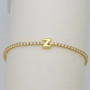 Close-up of a gold-plated tennis bracelet with a bubble letter Z and clear cubic zirconia stones.