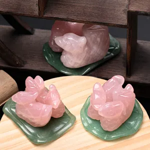 Natural rose quartz mandarin duck crystal carving detail with green leaf base decor.