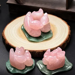 Detail shot of natural rose quartz carved mandarin duck crystal ornaments for wedding gift decor.