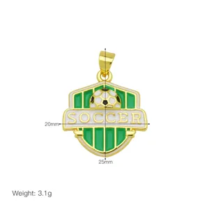 Close-up of gold enamel soccer pendant, sports theme metal jewelry accessory detail view.