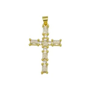 Gold plated cross pendant detailed view featuring sparkling baguette and round cubic zirconia.