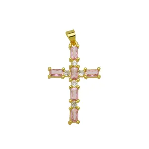 Detailed close-up of gold plated cross pendant featuring sparkling pink baguette zirconia stones.