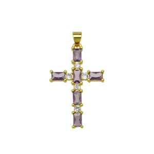 Detailed view of 18k gold plated cross pendant with purple and clear cubic zirconia stones.